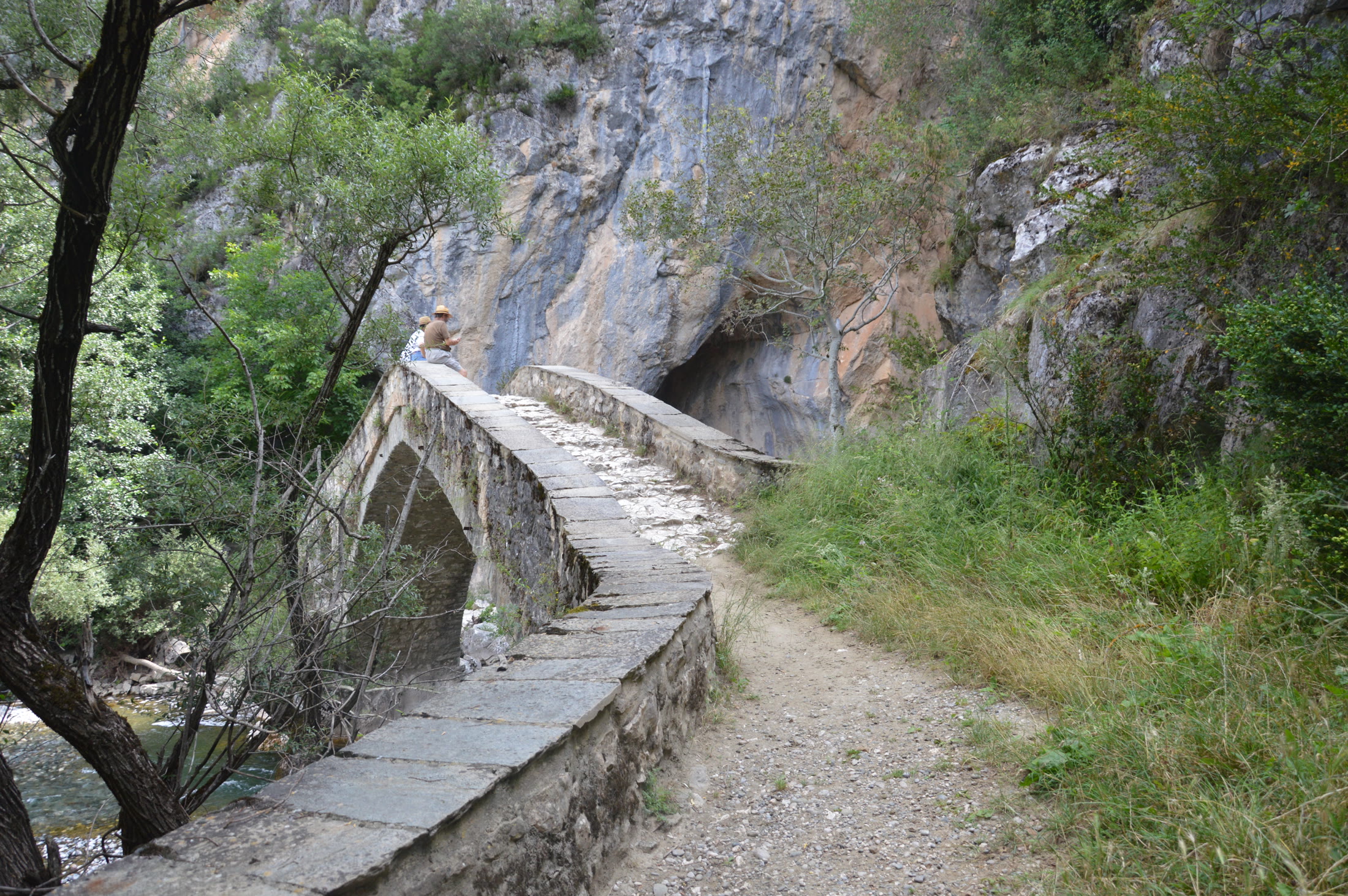 Historic stone bridge and trail access in the Grevena gorge