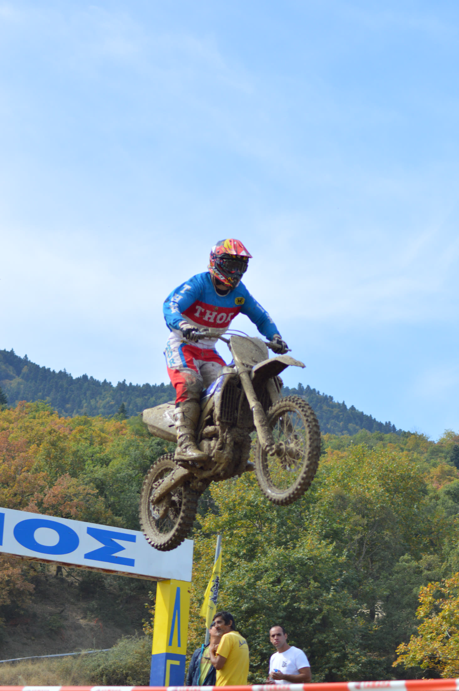 Off-road motorcycle rider jumping on an open mountain stage