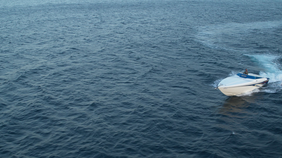 Fast boat crossing a coastal filming area